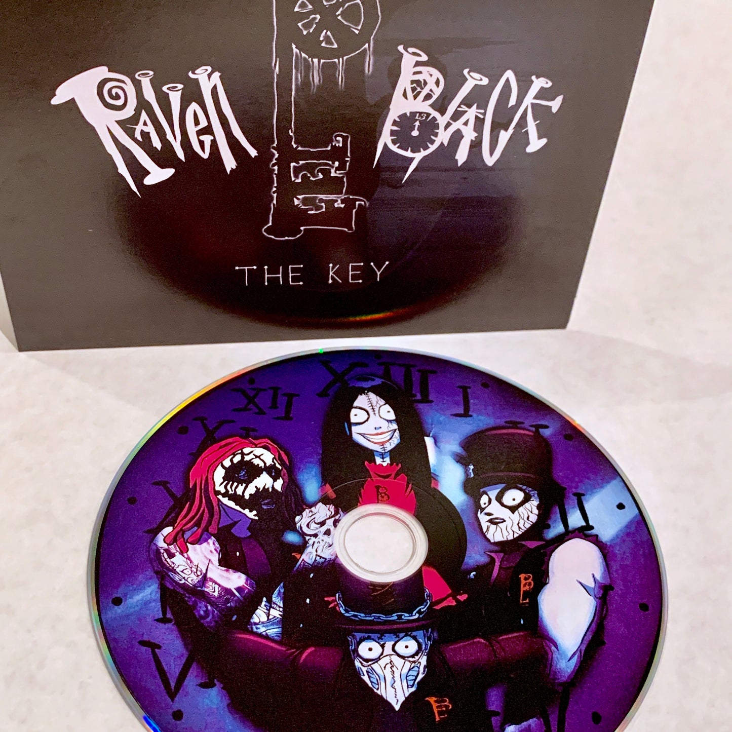 RavenBlack-TheKey-standard edition-blue disk-black and white cover