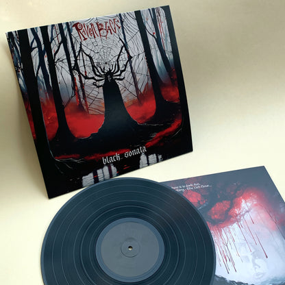 Raven Black's 'Back Sonata' - LP and jacket for the new album. Lead singer Raven is standing in the forest. She looks like a statue with antlers in front of a huge spiderweb. Black trees and silhouette. Black vinyl LP with black on black label