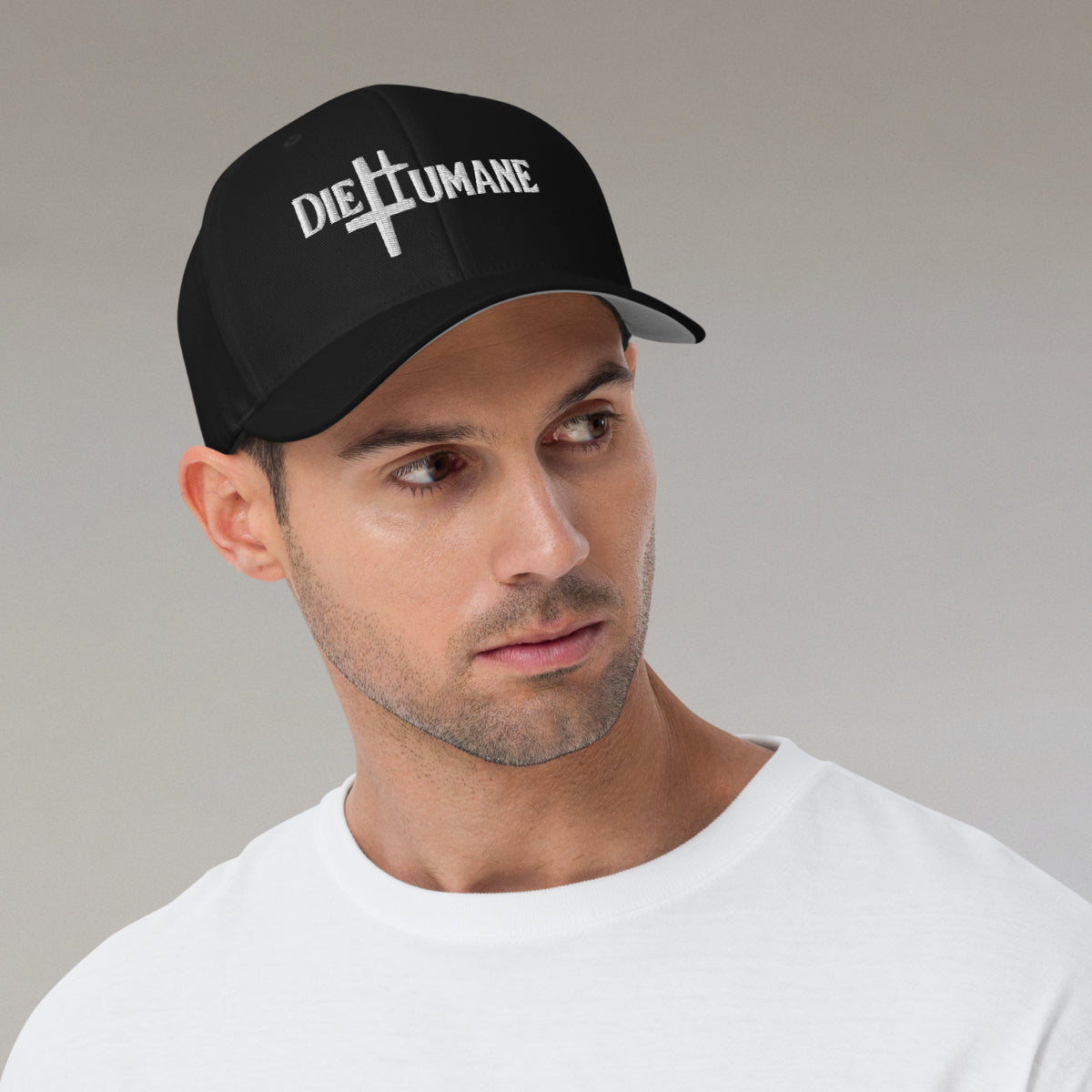 DieHumane hat. Male model with white shirt. Black baseball cap with white stitching, embroidery